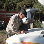 Brent signing The Forgotten Horses book on our little RV hood